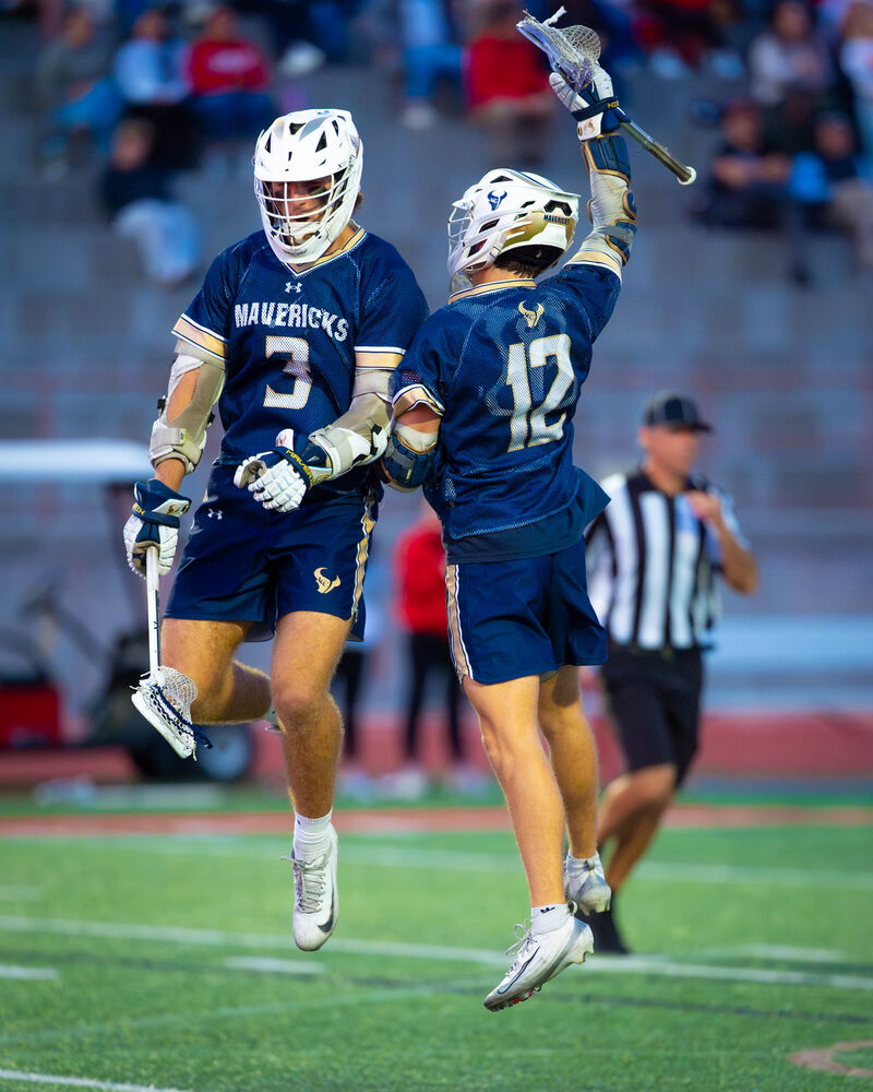Numbers 3 and 12 celebrating a goal