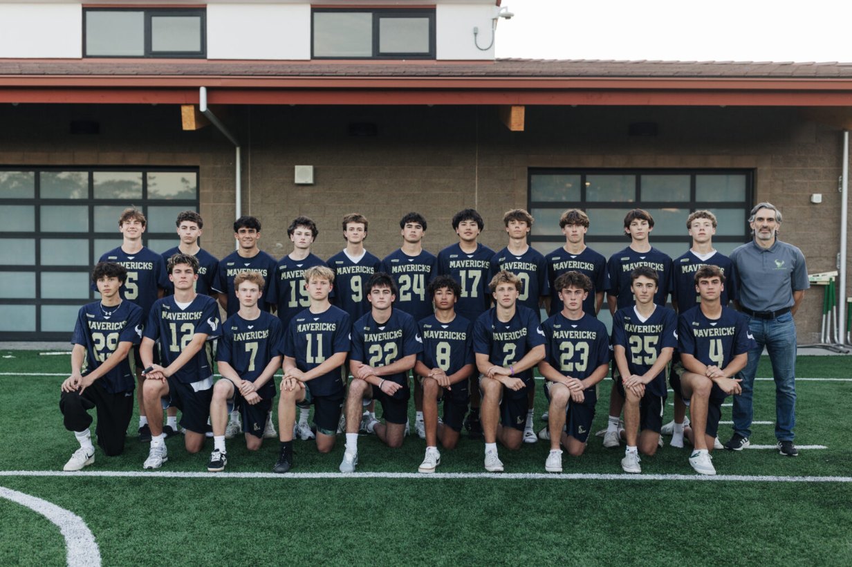 The Mavericks JV team and coach in front of the LCC field house